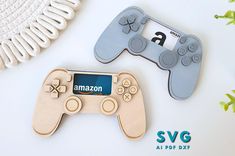 two wooden game controllers sitting next to each other on a white surface with the amazon logo