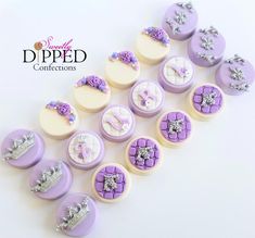 purple and white decorated cupcakes with tiaras on them are arranged in a row