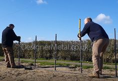 two men are working on some kind of fence