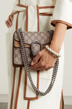 Gucci's 'Dionysus' shoulder bag is pretty hard to miss thanks to its distinctive tiger head hardware and 'GG' monogrammed canvas - that, and it's been spotted it on the arms of everyone from Margot Robbie to Beyoncé. Made in Italy, this mini take on the cult classic is trimmed with taupe suede and hand-painted edges. With a multitude of slip and zipped pockets, there's plenty of room for your cell phone, cardholder and lipstick. Gucci Dionysus Mini, Gucci Mini Bag, Horsebit Loafers, Designer Leather Bags, Gucci Purse, Bag Gucci, Bag Icon, Print Coat