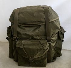 a large green backpack sitting on the ground