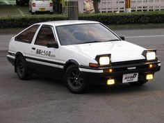 a white and black car parked in a parking lot