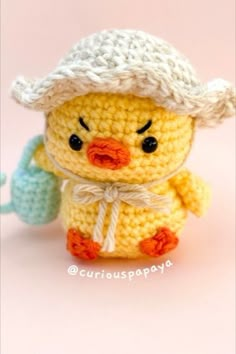 a small crocheted toy duck wearing a hat