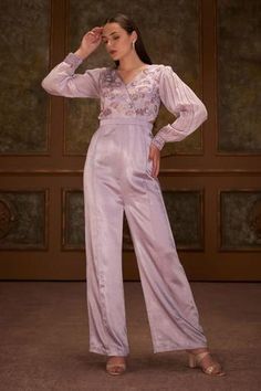 Lilac jumpsuit with floral hand embroidery on bodice, gathered sleeves and back cut-out. Brocade Jumpsuit, Lilac Jumpsuit, Pearl Cape, Embroidery Jumpsuit, Purple Jumpsuit, Floral Hand Embroidery, V Neck Jumpsuit, Embroidered Jumpsuit, Fusion Wear