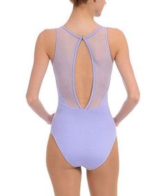 a woman in a purple bodysuit with sheer back and open sides, looking down at the