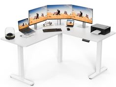 three computer screens sitting on top of a white desk next to a printer and mouse