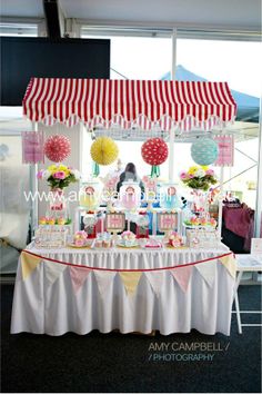 a table that has some food on it and umbrellas in the air above it