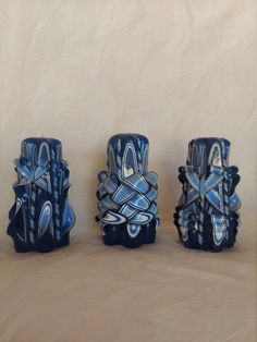 three blue vases sitting next to each other on a table