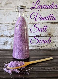 lavender vanilla salt scrub in a glass bottle next to a wooden spoon on a table