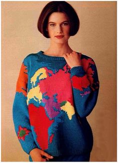 a woman is wearing a colorful sweater and posing for a magazine cover with her hand on her hip