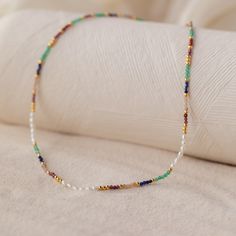 In need of a colorful pick me up to your everyday outfit? Our Oasis Rainbow Beaded Necklace marries boho style with the colors of the rainbow to take your summer look to the next level! Dainty yet bohemian, this beaded chain is the perfect accessory to wear and live your best colorful life ✨ Material: High Quality Solid 925 Sterling Silver Finish: 18K Gold Featuring a dainty ~2.5mm Rainbow Beaded Necklace with adjustable 16 to 18 inch chain Part of the Under the Sea Collection Model showcases a Bohemian Multicolor Jewelry With Tiny Beads, Bohemian Rainbow Beaded Necklaces With Natural Stones, Bohemian Rainbow Beaded Necklace With Natural Stones, Multicolor Spiritual Jewelry For Summer, Multicolor Spiritual Summer Jewelry, Adjustable Multicolor Necklace With Gold Beads, Bohemian Rainbow Necklaces With Natural Stones, Bohemian Rainbow Beaded Necklaces For Beach, Summer Multicolor Beaded Necklaces With Natural Stones