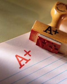 a rubber stamp with the letter a and an x on it next to a piece of lined paper