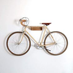 a wooden bicycle mounted to the wall