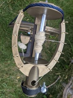 an upside down view of a metal object in the grass