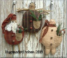 three handmade christmas ornaments hanging on a wooden wall