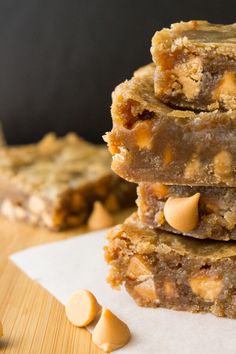 a stack of peanut butter bars sitting on top of a wooden table