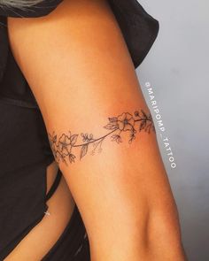 a woman's arm with flowers on it and the words, tattoo art written in cursive writing