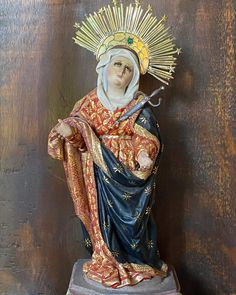 a statue of the virgin mary holding a cross