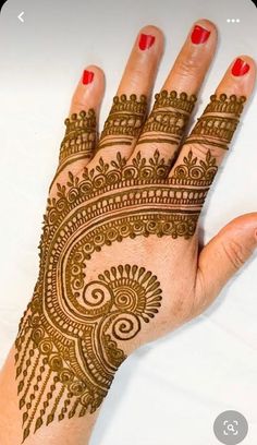 a woman's hand with henna on it