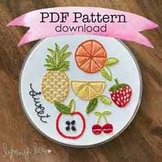 a embroidery pattern with fruit and berries on the front, along with a pink ribbon that says pdf pattern