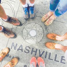 a group of people standing in a circle with their feet on each other's ankles