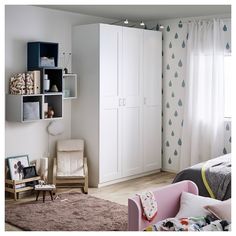 a bedroom with white furniture and blue wallpaper