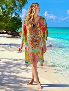 Embracing the ease of a sunny vacation lifestyle, the Phuket floral kaftan is designed in a vibrant oriental inspired print in tones of pink, turquoise and lime. Adorned with crystal embellishment on a  v-neckline with tie tassels and crafted from a luxurious silk viscose fabric with a matte satin handle and soft drape. This luxury cover up ticks all the boxes for glamorous resort wear and luxury getaways. PRODUCT DETAILS - Tie detail v-neck - Kimono sleeves - Loose fit - Side slits - Silk Visco Green V-neck Cover-up For Beach Season, Beachy Multicolor V-neck Cover-up, Bohemian Multicolor Print V-neck Kaftan, Multicolor V-neck Cover-up For Pool, V-neck Floral Print Festival Cover-up, Multicolor V-neck Cover-up For Beach Party, Green Floral Print Summer Cover-up, Summer V-neck Kaftan For Resort, Summer V-neck Kaftan For Pool