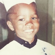 a young boy wearing a chef's hat and smiling