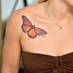 a woman with a butterfly tattoo on her chest