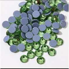 some green and purple stones on a white surface