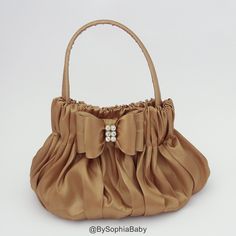 "ANTIQUE GOLD BOW HANDBAG - Unique Handcraft Bow placed on a fabric Handbag. - Purse Dimension : approx. 6\"W x 6\"H ( not counting with handles) - Please see picture #3 for proportion, baby model is 2 years old. - We make it in many colors, to see the colors available please type \"687\" in our shop browser and the colors will show up. Thank you for visiting our shop, please contact us if you have any question." Baby Purse, Toddler Purse, Beads Bag, Bow Purse, Flower Handbag, Gold Purse, Diy Bag Designs, Fabric Handbags, Girls Purse