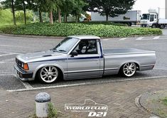 a silver truck parked on the side of a road