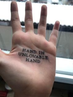 a hand with the words hand in unilovable hand written on it