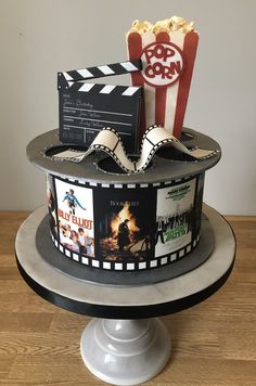 a movie themed cake with popcorn and movies