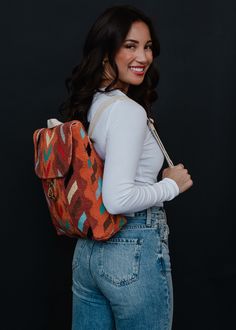 Orange with teal, brown, lilac, cream and black Aztec inspired backpack Clasp closure on the front Adjustable straps and handle Measures 14" x 11.5" x 4.5" 100% Cotton Lining: 100% Polyester Casual Brown Backpack With Removable Pouch, Multicolor Backpack With Adjustable Straps, Multicolor Everyday Backpack With Adjustable Straps, Multicolor Standard Backpack With Adjustable Straps, Multicolor Backpack With Adjustable Straps For Everyday Use, Trendy Brown Tote Backpack, Multicolor Travel Backpack Satchel, Multicolor Satchel Backpack For Travel, Multicolor Shoulder Backpack For On-the-go