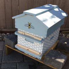 a beehive sitting on top of a wooden pallet