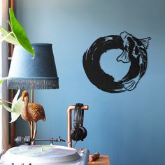 a room with a lamp and a painting on the wall that has a fish in it