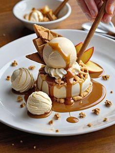 a plate topped with ice cream and caramel sauce