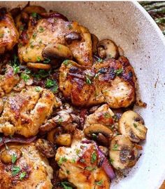 chicken and mushrooms in a white bowl with parsley on the side, ready to be eaten