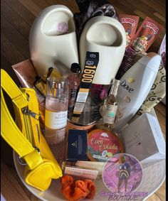 a white plate topped with lots of different types of cosmetics and personal care products on top of a wooden floor