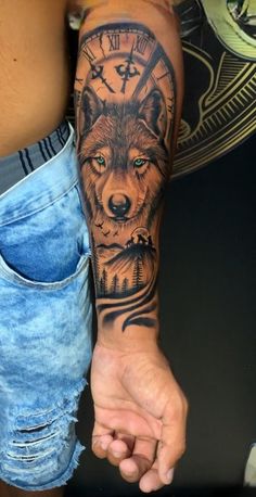 a man with a wolf tattoo on his arm holding the hand of another person's wrist