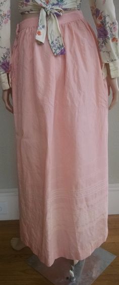 "This is a romantic high-waist pink maxi skirt from the 1950's. It is a delicate pink color with subtle cream embroidery at the bottom. The high waist quickly flares to a generous hip measurements (see below for exact measurements). Zipper and hook-and-eye closure on the left side, no pockets. The skirt fits like a modern small with the limiting factoring being the high waist measurement. The skirt is not lined and the fabric feels like a wool blend with a little stiffness and itchy-ness to it. Pink Pleated Feminine Maxi Skirt, Feminine Pink Pleated Maxi Skirt, Spring Long Inseam Flowy Skirt, Daywear Maxi Skirt With Lining, Lined Maxi Skirt For Daywear, Pink Lined Skirt For Daywear, Maxi Length Lined Skirt For Daywear, Pink Lined Maxi Skirt, Pink Full-length Spring Skirt