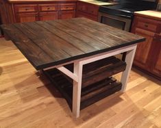 a kitchen island made out of pallet wood in the middle of a wooden floor