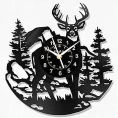 a clock with a deer and trees on it