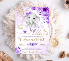 an elephant baby shower party with purple flowers and gold glitters on the bottom, it's girl