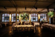 an empty dining room with tables and chairs set up for a formal function in front of large windows