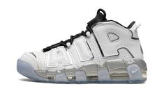 The Women’s Nike Air More Uptempo “White Metallic” is a women’s version of the retro basketball shoe with a flashy appearance.  In the “White Metallic,” Nike updates the Air More Uptempo, the shoe worn by Scottie Pippen with the Chicago Bulls during the 1995-96 NBA season, with a versatile look.  The shoe features a white leather construction with its signature graffiti-inspired “AIR” branding on the sides outlined in metallic silver.  The black mesh tongue, laces and elastic overlay straps add Clean White Leather, Retro Basketball Shoes, Scottie Pippen, New Nike Air, Metallic Shoes, Cheap Nikes, Hot Sneakers, Sketchers Sneakers, Black Mesh