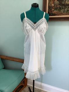 Simple Vintage Nylon Slip , 50's Lingerie (White) Lace trim with a crinkled boarder  Sweetheart bodice with Eyelet lace  Puckering at Brest line for a smoother fit  Adjustable shoulder straps  Size M Bust C-36 Waist - 36 1/2" Hip -44" Length -36" + adjustable shoulders straps Excellent vintage condition Vintage Fitted Ruffle Nightgown, Fitted Vintage Nightgown With Ruffles, Vintage Fitted Nightgown With Ruffles, Fitted Retro Sleepwear For Loungewear, Retro Fitted Sleepwear For Loungewear, Vintage Sleeveless Ruffled Sleepwear, Fitted Coquette Nightgown With Lace Trim, Vintage Camisole Sleepwear For Bedtime, Vintage Camisole Sleepwear