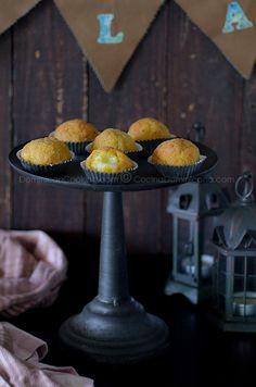 some muffins are sitting on a cake plate