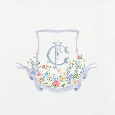 a watercolor drawing of a monogrammed crest with flowers